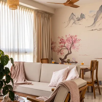 A beautiful example of Japandi design, where a hand-painted cherry blossom mural becomes the soul of the room. The natural wood furniture and soft textiles create an atmosphere of pure tranquility.