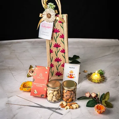 This elegant Diwali hamper is one of our signature festive offerings. It features a custom-printed jute bag containing premium assorted dry fruits in glass jars, artisanal chocolates, and traditional items like a decorative diya and incense sticks. We design these to be a complete, thoughtful gift for the festival of lights.