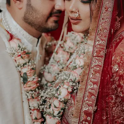An intimate moment right after the Jaimala ceremony, where the world fades away. I focused on their serene expressions and the beautiful floral garlands that bind them, capturing the quiet beginning of their forever.