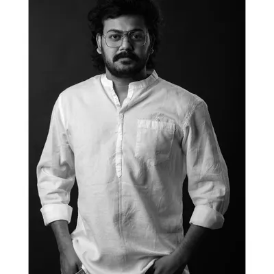 A classic black and white headshot for an actor. The direct gaze and simple lighting create a strong, confident portrait that lets his personality shine through.
