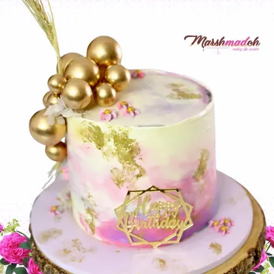 Tall cakes are so chic, and I love creating them. For this birthday cake, I used a watercolour buttercream technique with delicate gold foiling and a cascade of golden spheres for a modern, celebratory look.