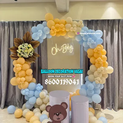 A modern and chic "Oh Baby" setup with a teddy bear theme. The unique color combination of mustard yellow, baby blue, and cream balloons creates a warm and stylish backdrop for a baby shower.