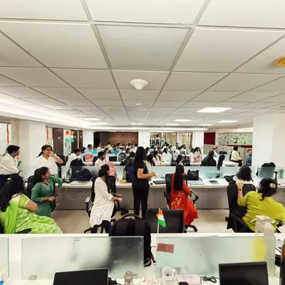 A wide shot of a corporate yoga wellness program I conducted. Even in a busy office, we can create a space for employees to breathe, stretch, and reset.