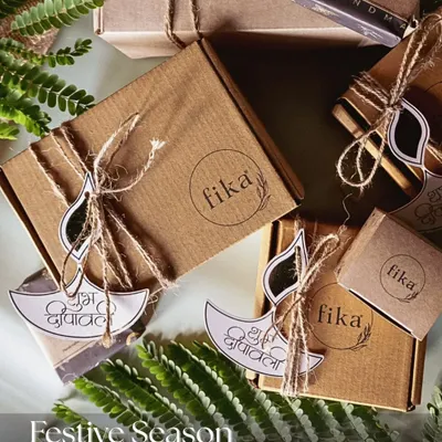For the festive season, I curate these eco-friendly gift hampers. This overhead shot shows my handmade products packed in simple kraft boxes, tied with jute twine and adorned with 'Shubh Deepavali' tags for a sustainable and beautiful gifting option.