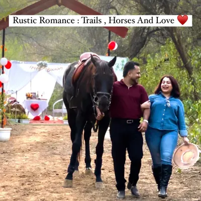 A happy couple walks with one of our majestic horses towards their private romantic setup. This is the perfect start to our "Trail of Love" experience, blending adventure with an intimate celebration.