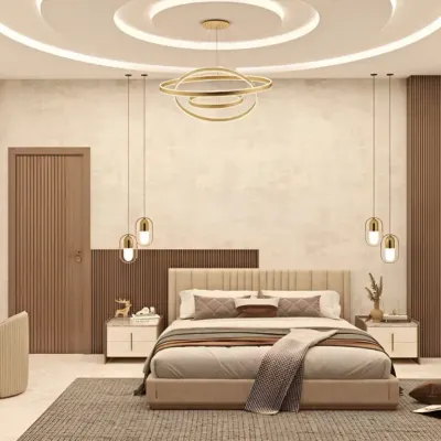 An elegant master bedroom featuring a sophisticated color palette of beige and brown. The design includes a circular false ceiling with cove lighting, stylish pendant lights, and a dedicated vanity area.