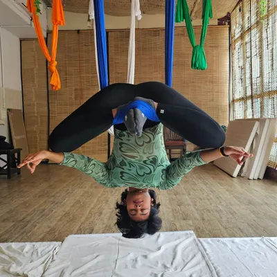 Finding balance and peace in an inverted butterfly pose during my aerial yoga certification. This posture is amazing for opening the hips and decompressing the lower back, all while being fully supported by the hammock.