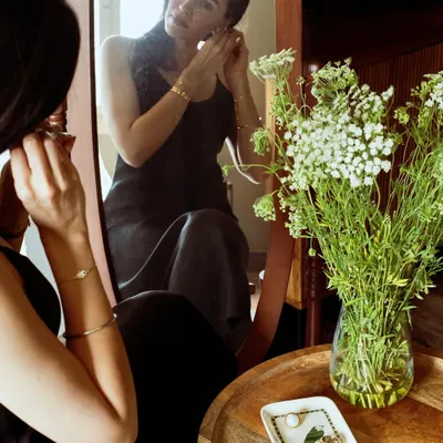 A personal moment of getting ready, captured for Patrika Gift Shop. This shot shows their jewelry being worn in a natural, intimate setting, telling a story of self-care and quiet elegance.