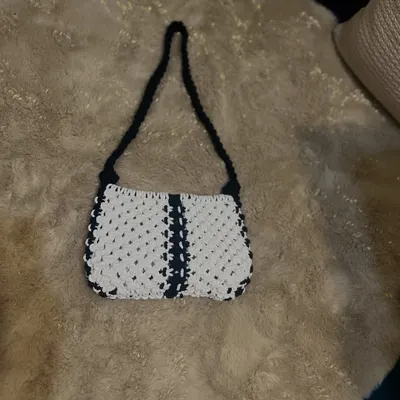 My take on the classic baguette bag, handcrafted with macrame. This black and white design is timeless and chic, perfect for a stylish shoulder bag that holds your essentials.