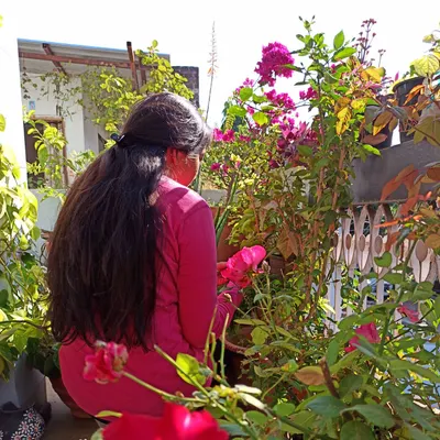 Me in my home garden, surrounded by roses and bougainvillea. Whether it's a large terrace or a small balcony in a new city, I can show you how to start your gardening journey anywhere.