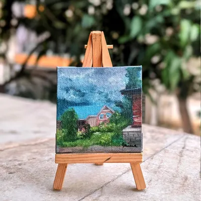The Manali homestay painting displayed on its easel. This shows how a custom painting of a special place can become a beautiful piece of decor, always reminding you of that happy travel memory.