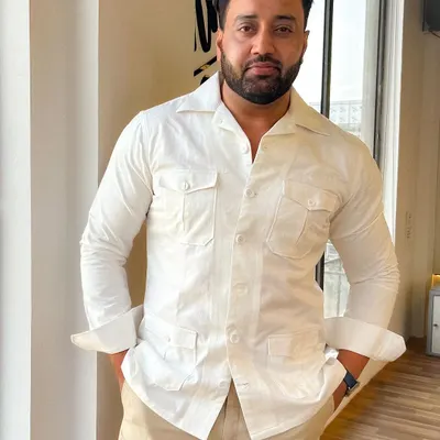 Mr. Vipul Chauhan looking sharp in a custom Levelline safari shirt. Paired with beige linen trousers, it's the epitome of sophisticated summer style.