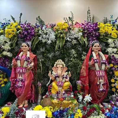 A grand floral arrangement for a complete Gauri Ganpati installation. I designed matching garlands for both Gauri and Ganpati and surrounded them with a vibrant wall of fresh flowers to create a stunning display.