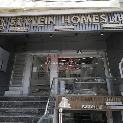 The completed entrance for the StyleIn Homes office in New Delhi. The design features bold signage and a modern glass entryway, creating an immediate impression of professionalism and style for this real estate firm.