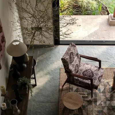 A top-down view of the living area in Maison Rouge, a family vacation home in the Konkan belt. The design balances contemporary details with traditional materials, creating an oasis that connects the family to their ancestral roots.