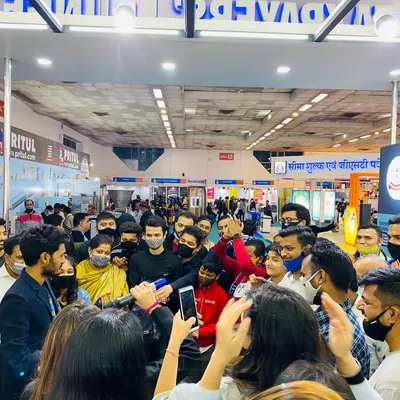 A packed crowd surrounds the booth during a performance at a major exhibition. This is how I turn a standard trade show booth into a must-see attraction.