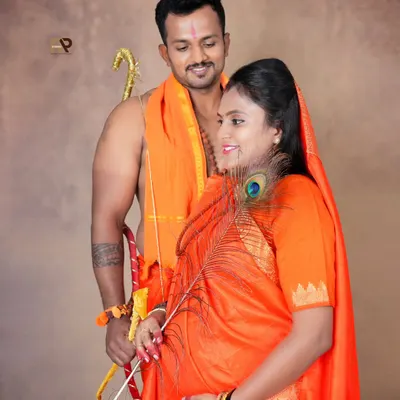 A powerful and artistic maternity portrait from our Seetha-Ram series. The husband holds a bow while the wife holds a peacock feather, creating a symbolic and visually striking image.