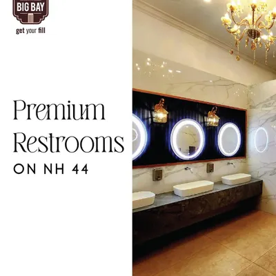 We are proud to offer premium, hotel-quality restrooms on NH44. This image showcases our clean, modern, and luxurious washroom facilities, complete with elegant chandeliers and backlit mirrors.