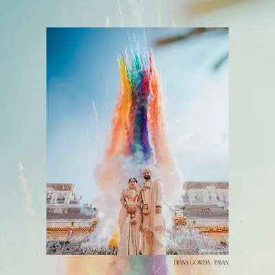 This epic wedding shot shows the power of a coordinated look. The groom's classic ivory sherwani and dhoti were designed to perfectly match his bride's attire, creating a visually stunning and harmonious picture.
