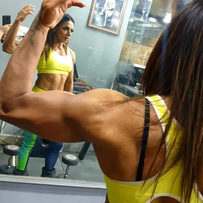 Checking my bicep definition in the mirror. My nutrition plans are tailored to help you build lean muscle mass while keeping body fat low, creating this kind of sharp, defined look.