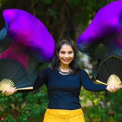 This is from a magazine photoshoot last year. Holding these vibrant silk fans, I feel like I'm holding a pair of wings. They bring such a sense of power and elegance to my dance.