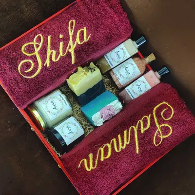 This super luxurious red and gold hamper is a showstopper. It features rich maroon towels with custom names, along with a full set of my best products like Shea Butter, coffee scrub, and cold process soaps.
