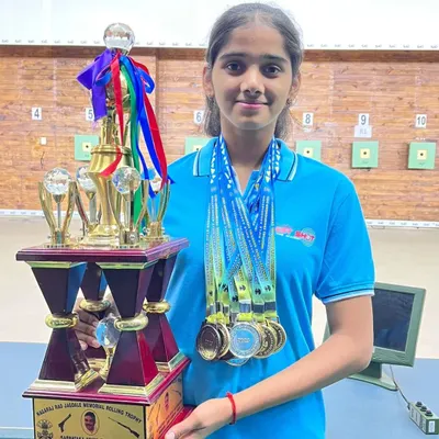 Our rifle shooter Anushka holding a well-deserved trophy and a collection of medals after a series of outstanding performances in the 10m air rifle event.