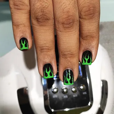 A close-up of the hand-painted neon green flames. The precision of the lines on the black base creates a powerful and fiery look, perfect for anyone wanting to make a statement.