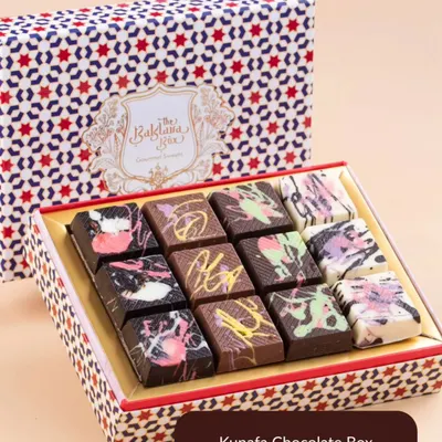 A box of my viral Dubai Kunafa Chocolate Bars. This image shows the beautiful, artistic design of the assorted chocolate box, featuring flavors like pistachio, hazelnut, and peanut butter.