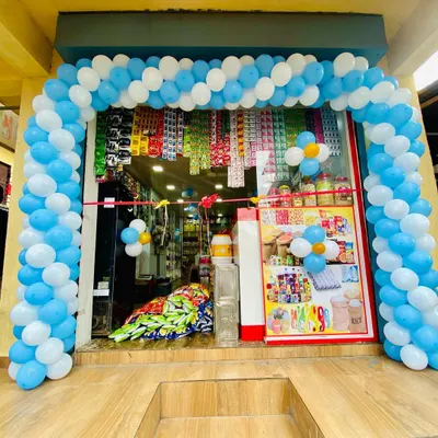 A blue and white balloon arch for the grand opening of a local shop, creating a festive and welcoming entrance.