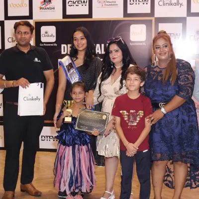 Young winners of the Global Kids Fashion Week proudly pose with their trophies and certificates alongside our jury. We are dedicated to encouraging and rewarding the next generation of talent.