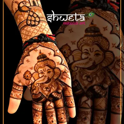 A powerful and detailed portrait of Lord Ganesha on the palm. This design is perfect for starting a new journey with blessings, featuring a cute Bal Ganesha figure.