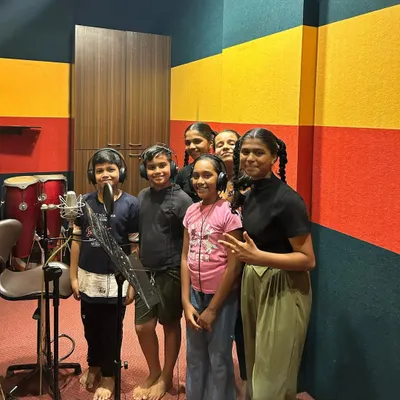 A group of our students inside a professional recording studio, ready to sing into the condenser microphone. This is a fantastic opportunity for them to understand how professional music is made.