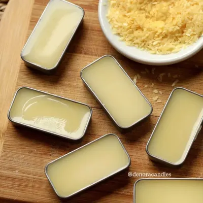 My handcrafted solid perfumes are made with skin-friendly ingredients and come in convenient slider tins. This image shows the product alongside raw beeswax, highlighting the natural components I use.
