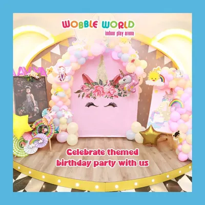 A magical unicorn-themed birthday setup. This beautiful backdrop with a floral unicorn, pastel balloons, and a golden arch creates a truly enchanting party atmosphere.