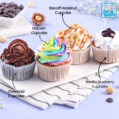 A lineup of some of our most popular cupcake flavors. This image showcases the variety we offer, including the decadent Overload, colorful Unicorn, nutty Biscoff Hazelnut, and fruity Vanilla Blueberry.