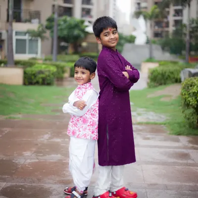 A fun and confident pose from two brothers during an outdoor photoshoot. We love capturing the bond between siblings.