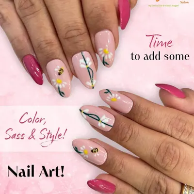 See the detail in our custom nail art. This design features a soft pink base with delicate white daisy art, complete with tiny bees and vibrant magenta accent nails for a cheerful, stylish look.