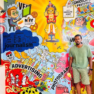 Here I am with the completed mural for the Nitte Institute of Communication. The artwork is a colorful doodle collage representing all the courses they offer, including journalism, VFX, animation, and photography, with a touch of local culture.