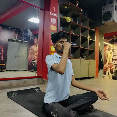 A student practicing Nadi Shodhana (alternate nostril breathing), a powerful pranayama technique I teach to calm the mind and reduce stress.