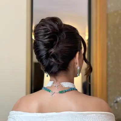 A detailed look at a voluminous, textured updo. I crafted this bun to have height and intricacy, making it a statement piece that looks stunning from every angle, perfect for an elegant evening function.