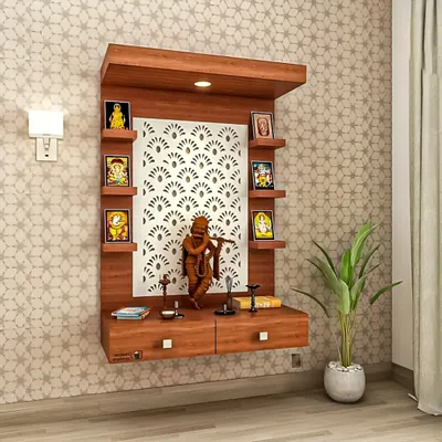 A modern, wall-mounted pooja unit with a beautiful laser-cut panel as the backdrop. The design includes small shelves for idols and drawers for storing prayer essentials, making it a compact and elegant solution.