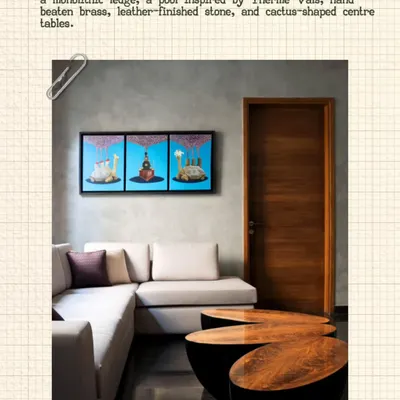 In this living space, a vibrant triptych of Gond art is perched on a monolithic ledge above the sofa. This placement transforms the traditional art form into a contemporary focal point, complemented by modern furniture and clean lines.
