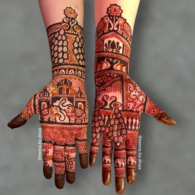 A royal-themed design featuring a majestic Ganesha in a palace window on one palm. The other hand is adorned with swans, peacocks, and elephants, creating a truly grand look.