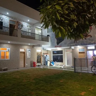 A wide view of our pet resort at night. You can see the spacious park, the boarding facility, and the indoor cafe area, all designed for comfort and fun.