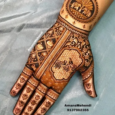 A full palm design showcasing a variety of traditional figures. It includes a circular wrist motif with elephants, a central peacock, and swans in a grid pattern.