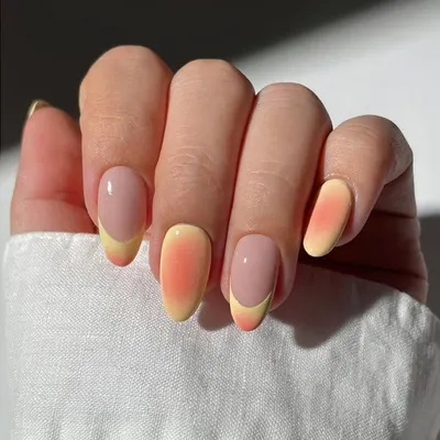 A beautiful ombre effect with a twist. This design features a sunset-inspired gradient on some nails, paired with a modern French outline on others, showing our creative combinations.