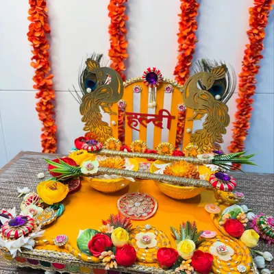 Embrace the sunshine with this gorgeous peacock-themed Haldi platter. The vibrant yellow base, golden peacock cutouts, and colorful floral details are perfect for bringing love, laughter, and a splash of color to your festivities.