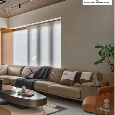 This living hall is an embrace of seamless style and comfort. The large leather sectional, layered rugs, and mix of neutral tones create a sophisticated yet inviting atmosphere, perfect for family life.