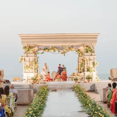 A wide view of the majestic beachside mandap at Sai Radha Heritage. The structure was designed to complement the vastness of the sea, creating a truly epic setting for the wedding vows.